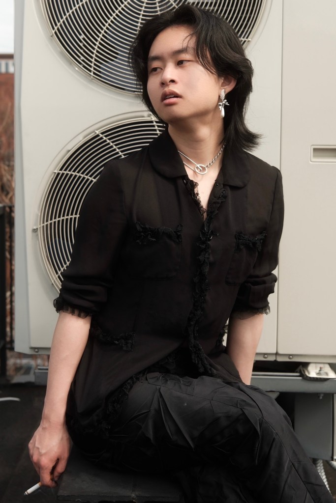 j smoking a cigarette in front of an HVAC unit